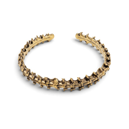 Trebor Style snake vertebrae bangle cast in reclaimed gold-toned metal with a textured, organic bone-like design.