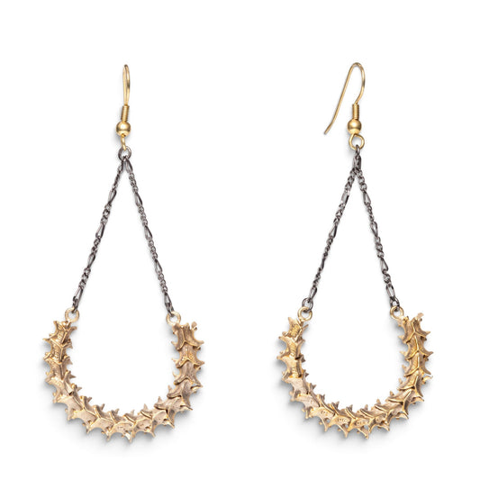 Trebor Style handmade snake vertebrae earrings with vintage chain and brass French hooks on a white background.