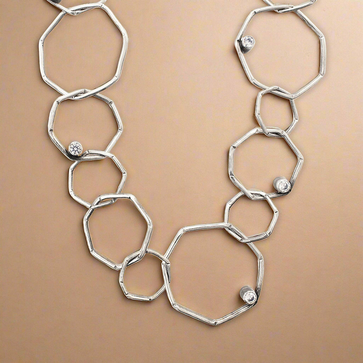 Trebor Style sterling silver geometric chain necklace with etched open links and bezel-set cubic zirconia accents.