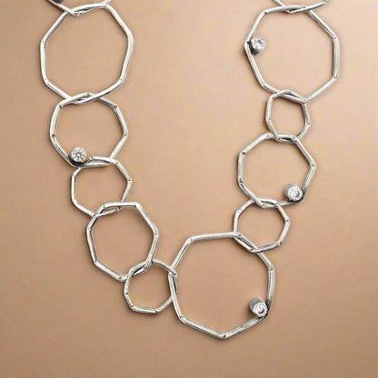 Trebor Style sterling silver geometric chain necklace with etched open links and bezel-set cubic zirconia accents.