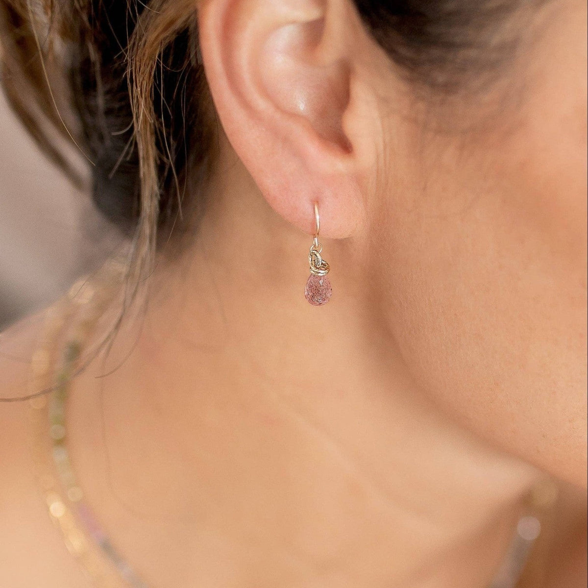 Trebor Style petite faceted strawberry quartz briolette drop earrings with gold-filled hooks worn on an ear