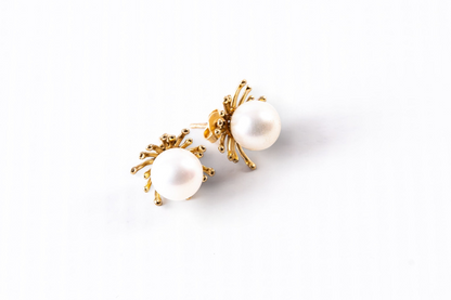Trebor Style sunburst stud earrings featuring white Japanese Akoya pearls set in 14k yellow gold.