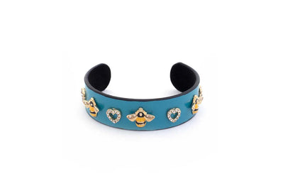 Trebor Style vegan leather cuff bracelet in teal with gold bee and crystal heart charms and black velvet lining.
