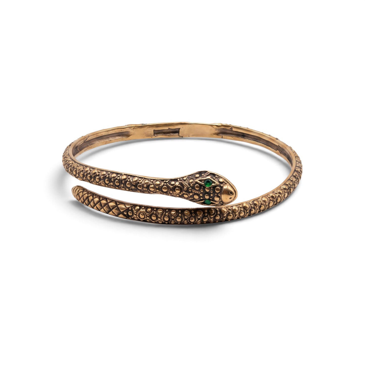 Trebor Style textured serpent bangle in gold with green gemstone eyes, featuring a flexible wrap-around snake design.