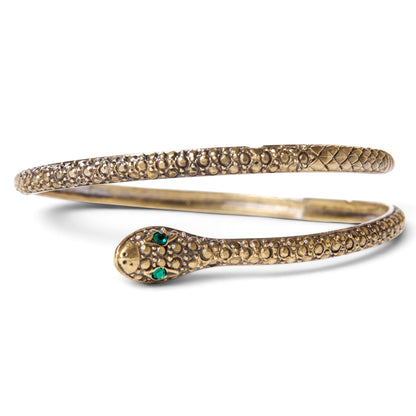 Trebor Style textured brass serpent bangle with green gemstone eyes, designed to wrap around the wrist or arm.