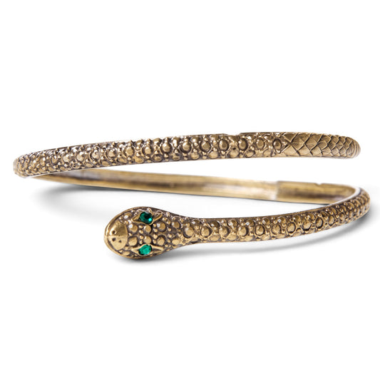 Trebor Style textured brass serpent bangle with green gemstone eyes, designed to wrap around the wrist or arm.