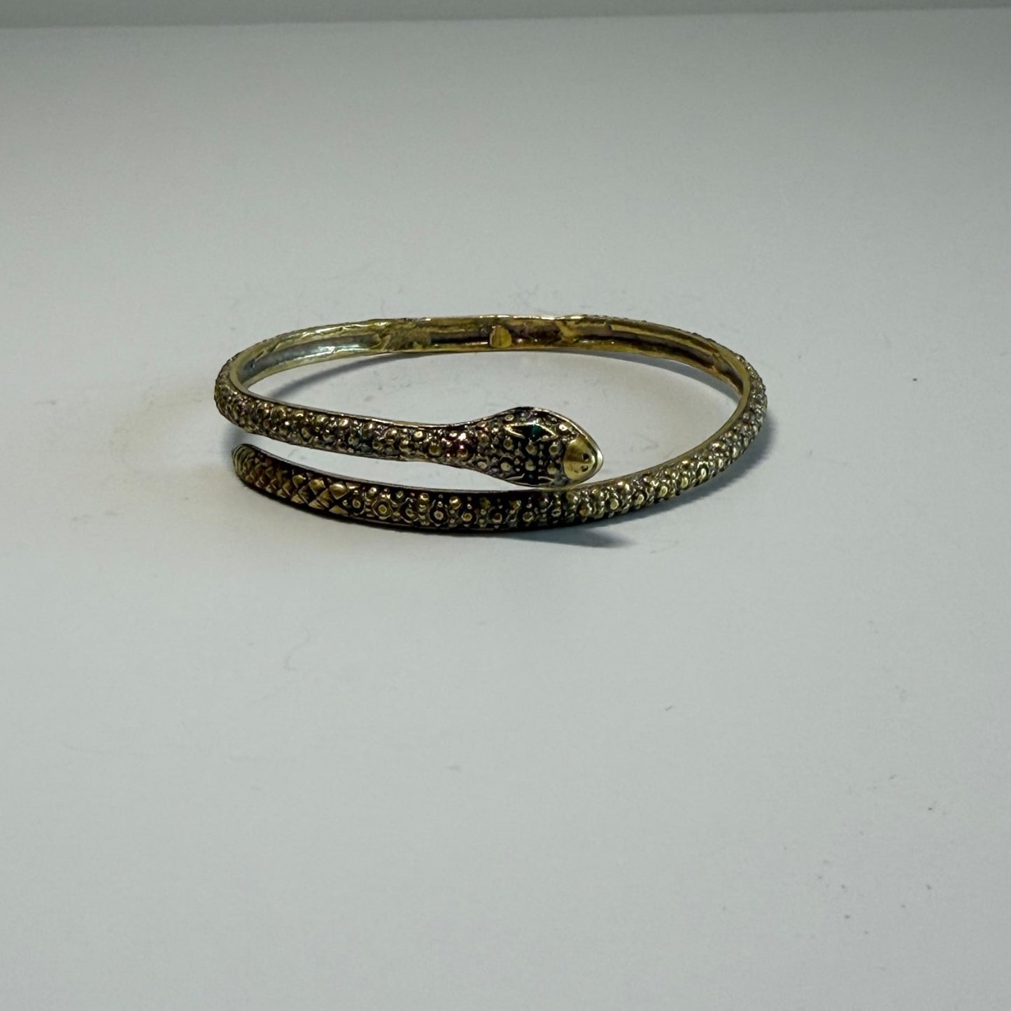 Trebor Style textured serpent bangle with a sinuous snake design, crafted in a metallic finish for a bold look.