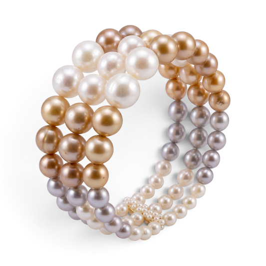 Trebor Style three strand elastic bracelet featuring graduated off-white, champagne, and soft gray freshwater pearls.