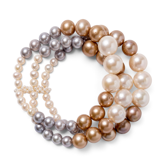 Trebor Style triple strand freshwater pearl bracelet in off-white, champagne, and soft gray with graduated sizes.
