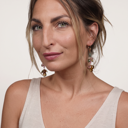 Trebor Style 14k yellow gold dangle earrings featuring multi-color pink and green tourmaline gemstones on a model.