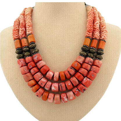 Trebor Style Masha Archer triple strand necklace featuring orange stained coral rondelles, pewter beads, and floral motifs