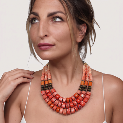 Trebor Style Masha Archer triple strand necklace featuring orange coral rondelles, pewter beads, and floral accents.