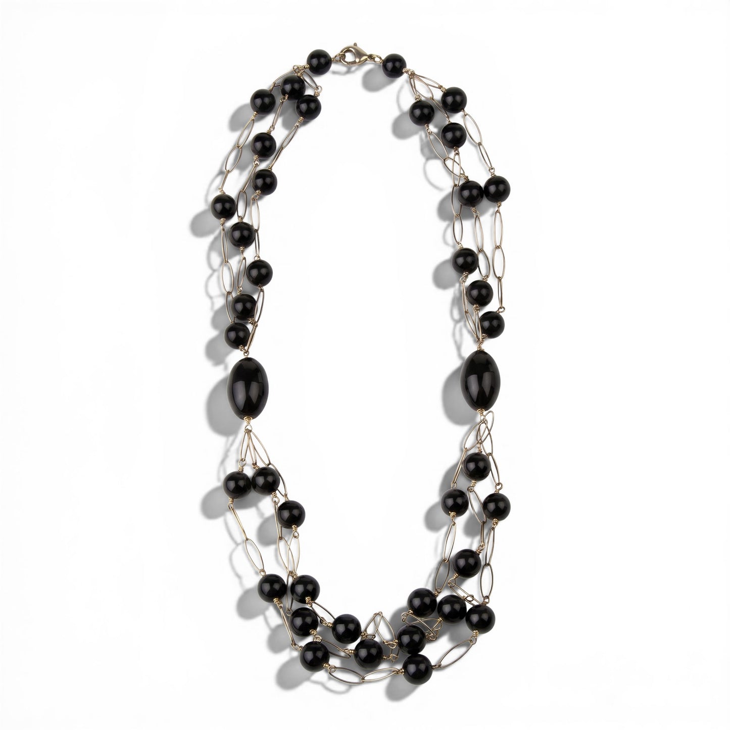Trebor Style long triple strand necklace featuring black onyx beads and rose gold plated sterling silver open links.
