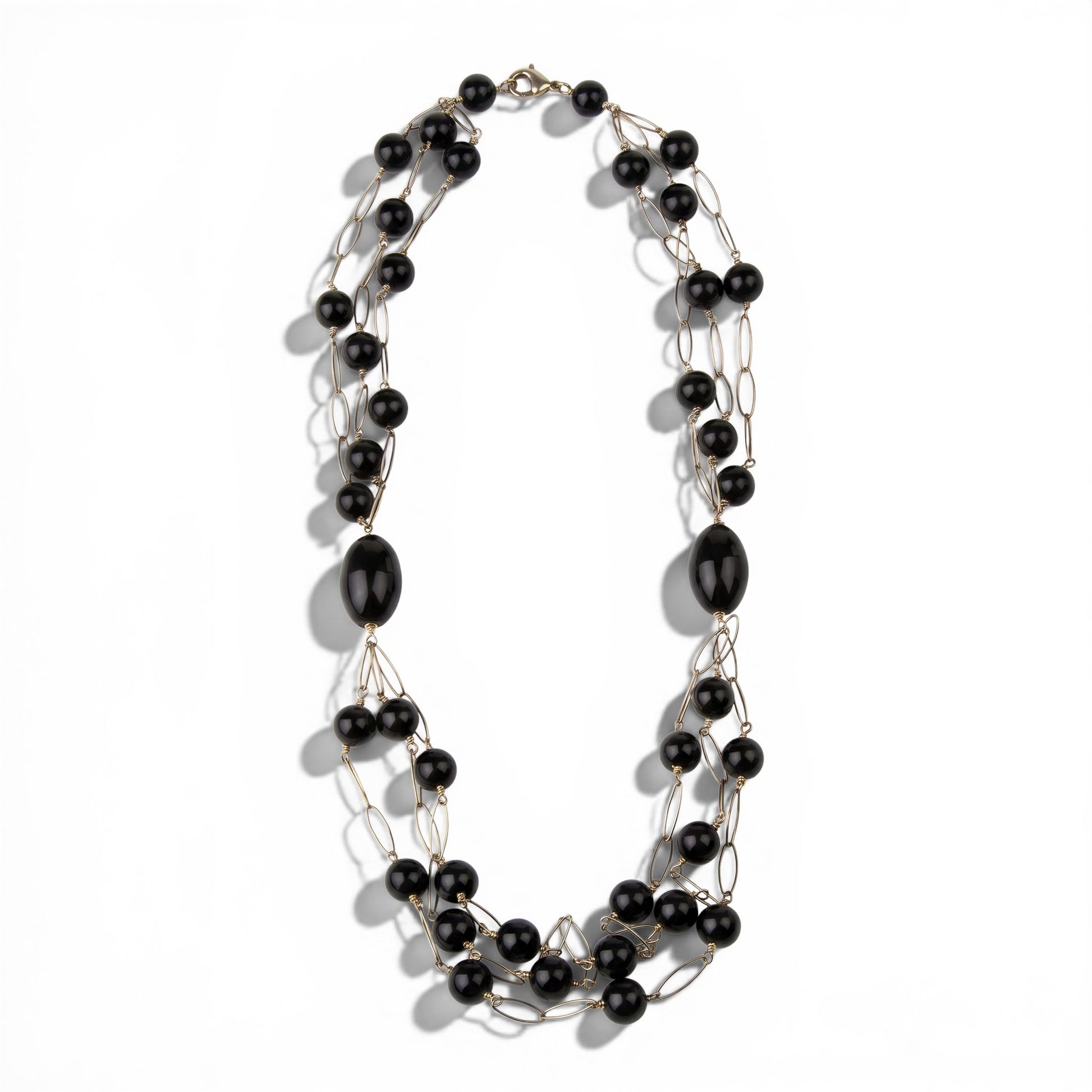 Trebor Style long triple strand necklace featuring black onyx beads and rose gold plated sterling silver open links.