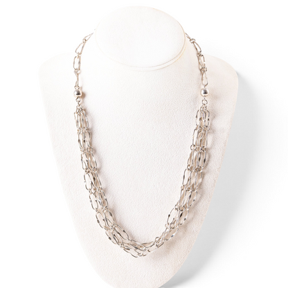 Trebor Style triple strand sterling silver necklace with oblong links displayed on a white jewelry bust