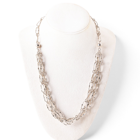 Trebor Style triple strand sterling silver necklace with oblong links displayed on a white jewelry bust