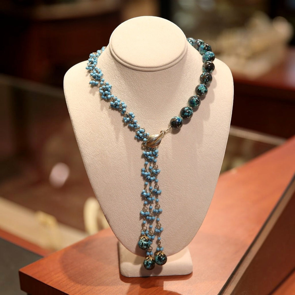 Trebor Style asymmetrical necklace featuring turquoise bead clusters, chrysocolla gemstones, and sterling silver accents.