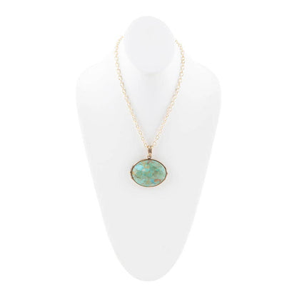 Trebor Style handcrafted necklace featuring a genuine turquoise pendant on a long golden bronze chain.