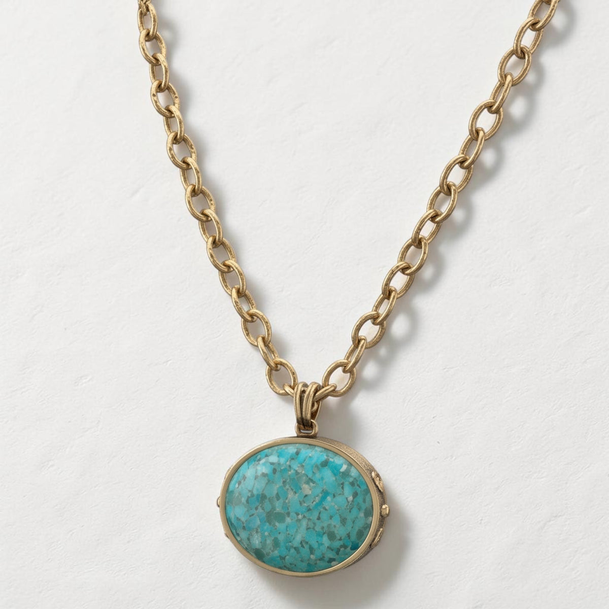 Trebor Style turquoise pendant necklace with a golden bronze chain and silver plated details in a Southwest style.