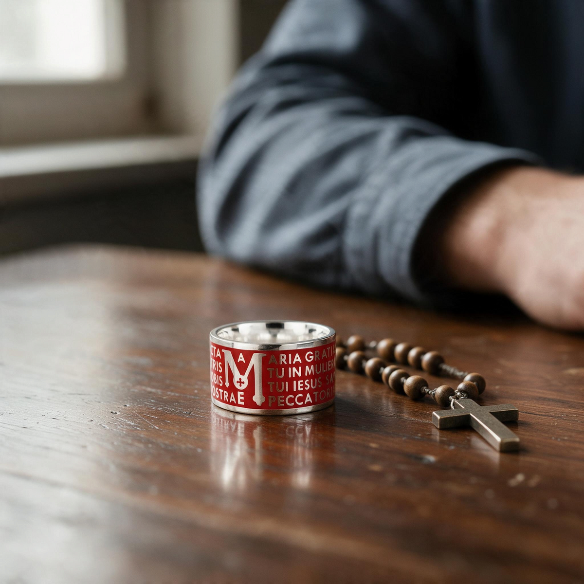 Trebor Style Tuum Animae Mater ring in sterling silver with red enamel and Ave Maria Latin text on a wooden table