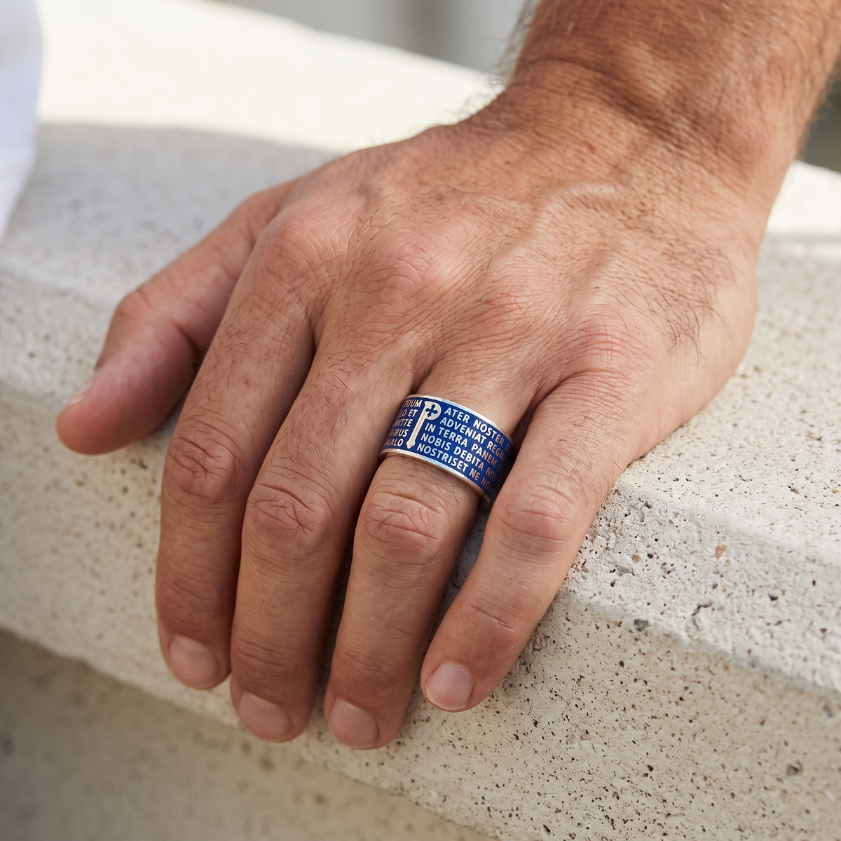 Trebor Style Tuum Animae Pater ring in sterling silver with blue enamel and Latin text on a man's finger
