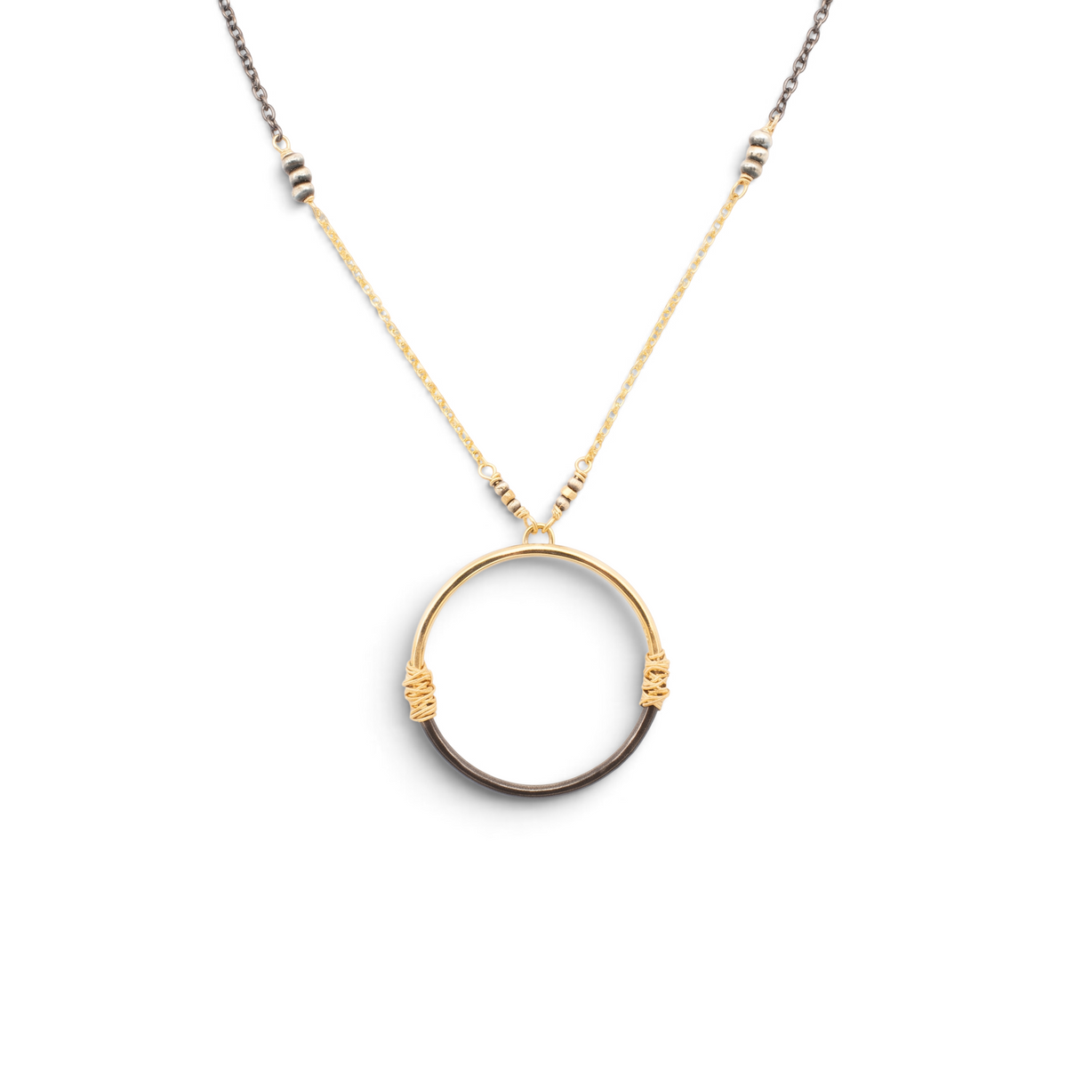 Trebor Style two-tone circle pendant necklace featuring wire-wrapped 14K gold-filled and oxidized sterling silver.