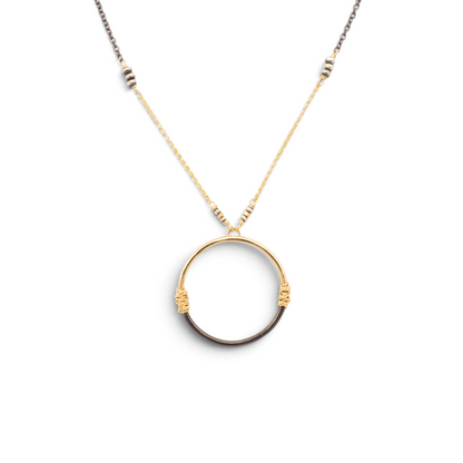 Trebor Style two-tone circle pendant necklace featuring wire-wrapped 14K gold-filled and oxidized sterling silver.