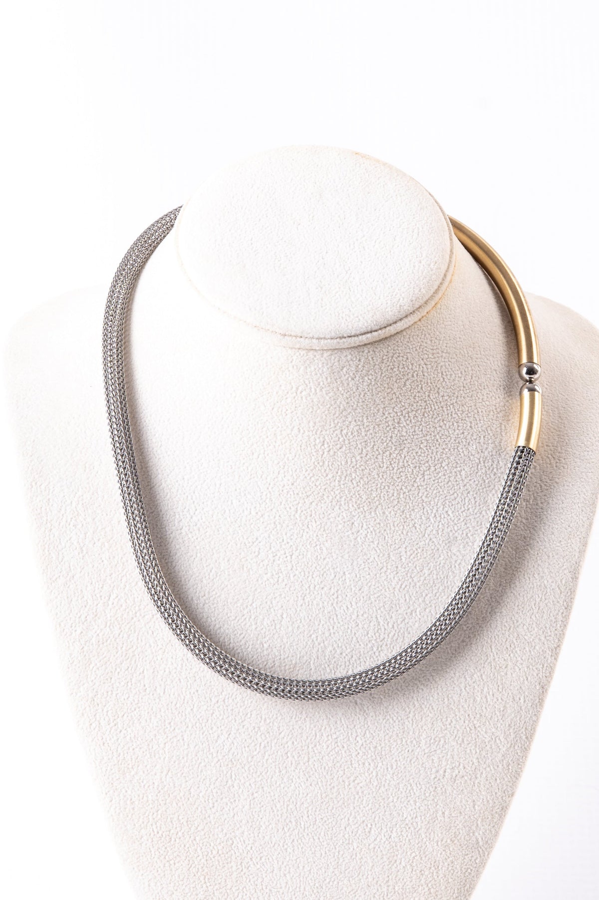 Trebor Style two-tone sterling silver mesh necklace with 14k gold plated accents and a magnetic closure on a display.