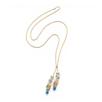 Trebor Style waterfall lariat necklace featuring kyanite, crystal, and Czech glass clusters on a matte gold brass chain.