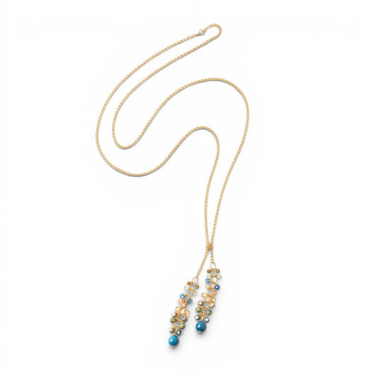 Trebor Style waterfall lariat necklace featuring kyanite, crystal, and Czech glass clusters on a matte gold brass chain.