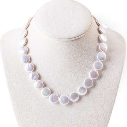 Trebor Style white freshwater coin pearl necklace with a 14k gold clasp on a display bust
