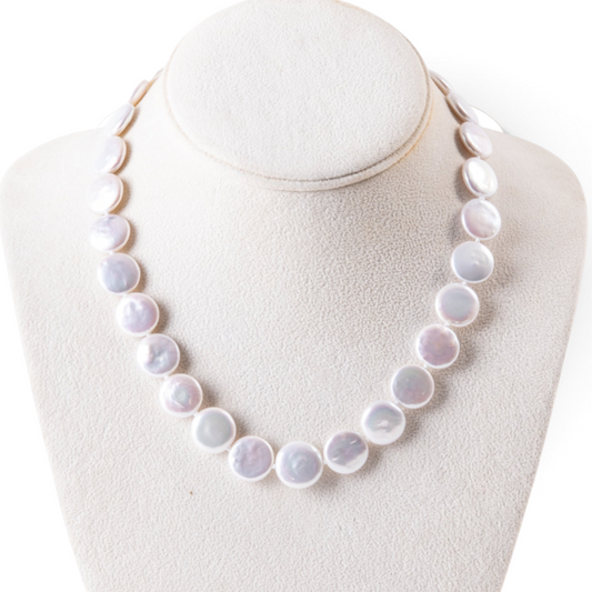 Trebor Style white freshwater coin pearl necklace with a 14k gold clasp on a display bust