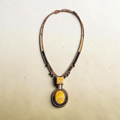 Trebor Style artisan statement necklace featuring a yellow jasper pendant with bronze, gold, and black glass beads.