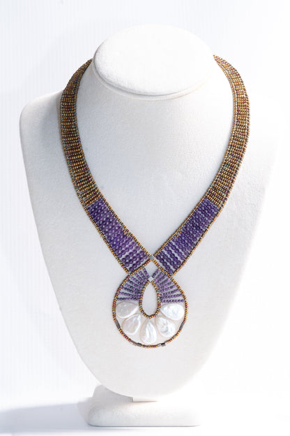 Trebor Style Ziio Ariane necklace featuring a Mother of Pearl fan pendant, Amethyst beads, and Murano glass accents.