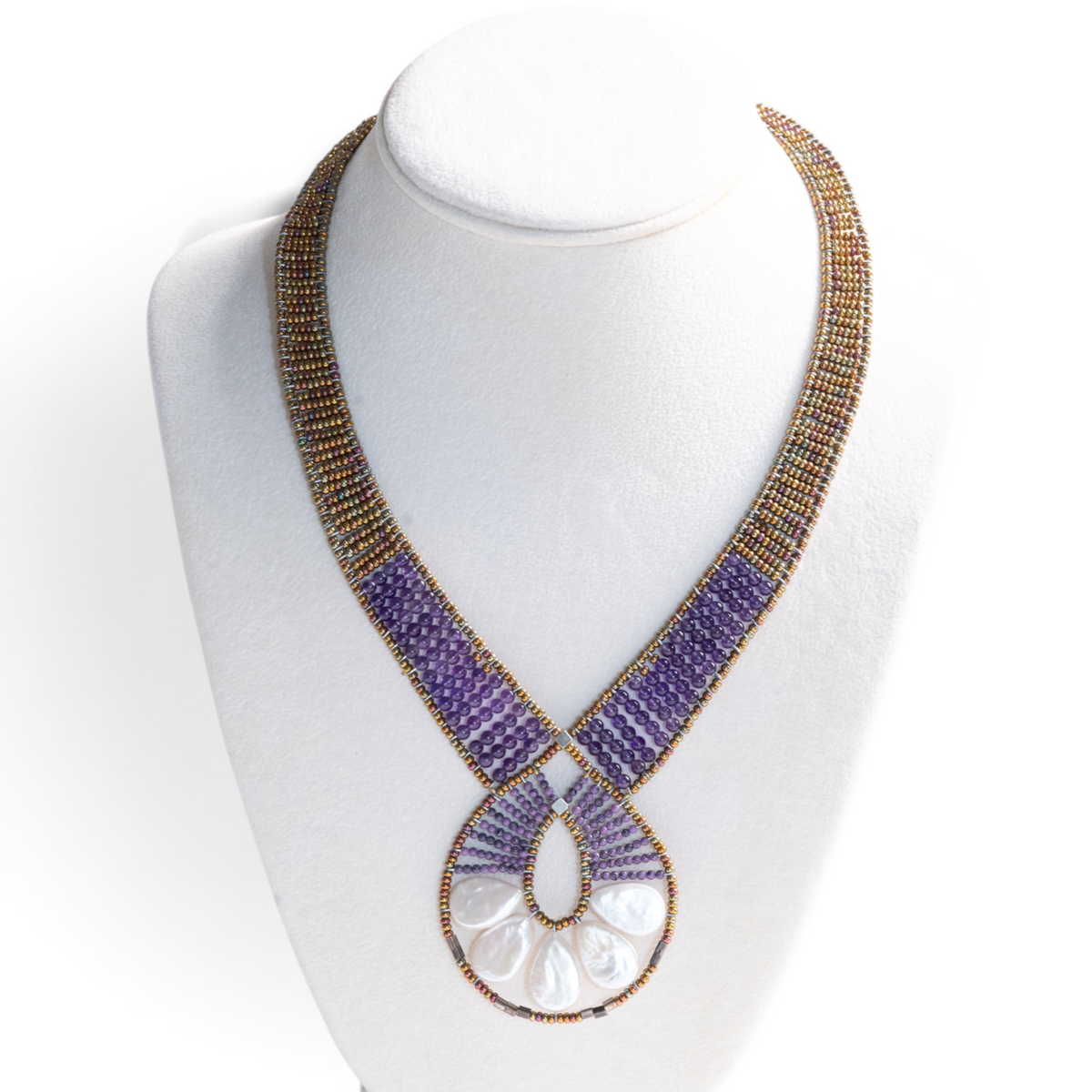 Trebor Style Ziio Ariane necklace featuring a Mother of Pearl fan pendant, amethyst beads, and Murano glass seed beads.
