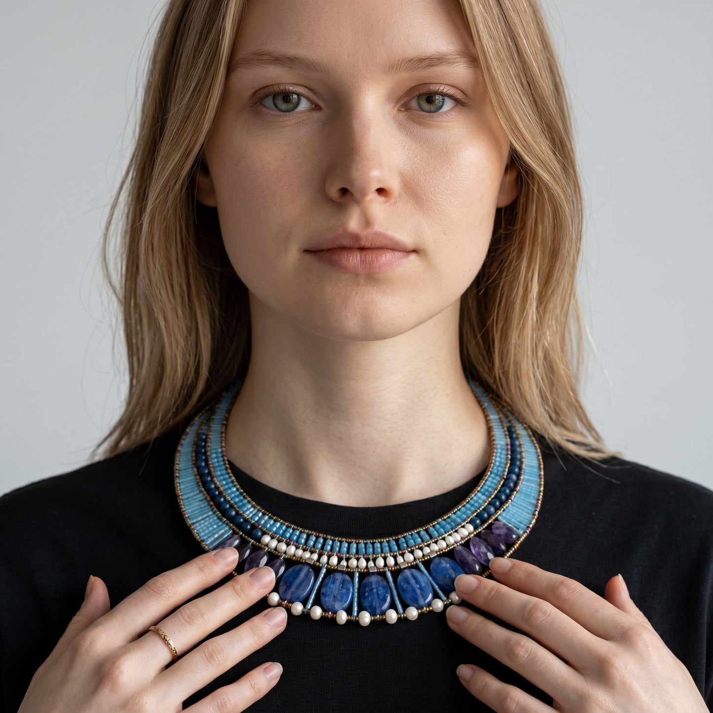 Trebor Style Ziio statement necklace featuring blue kyanite, iolite, zircon, and pearls on a model.