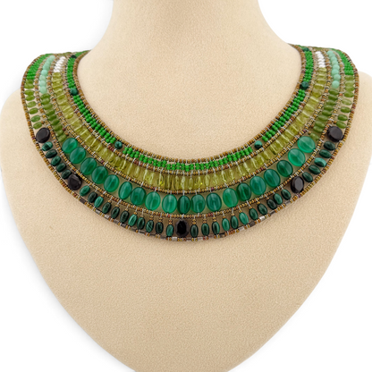 Trebor Style Ziio Fenice collar necklace featuring four rows of green gemstones and Murano glass beads on a display.