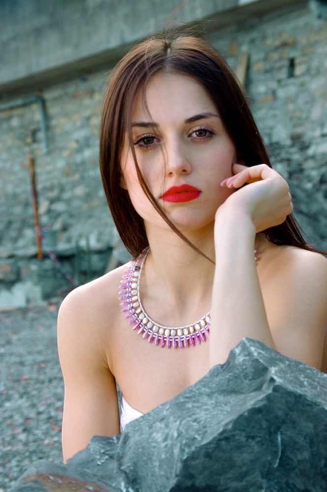 Trebor Style Ziio Mistinguett necklace featuring mother of pearl and pink bohemian glass beads on a woman.