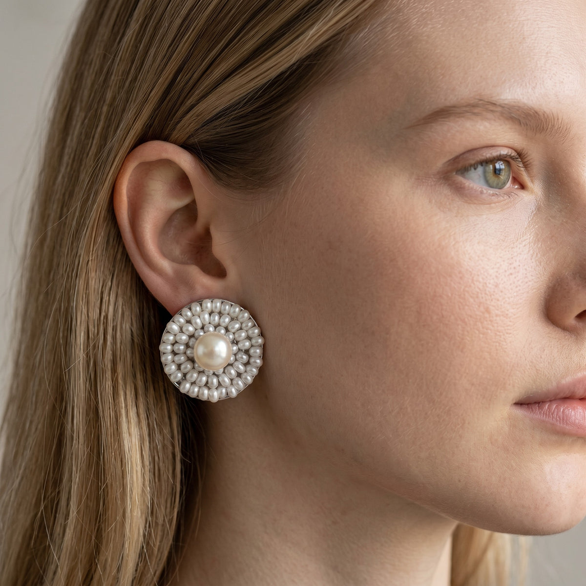 Ziio white freshwater pearl button earring framed by Murano glass beads, worn by a model