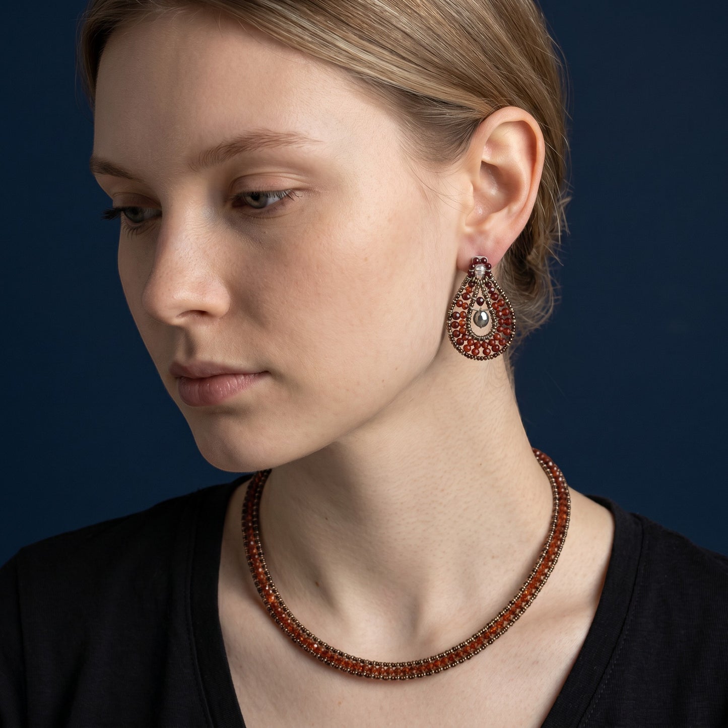Trebor Style Ziio red zircon and garnet oval drop earrings with Murano glass beads worn by a model.