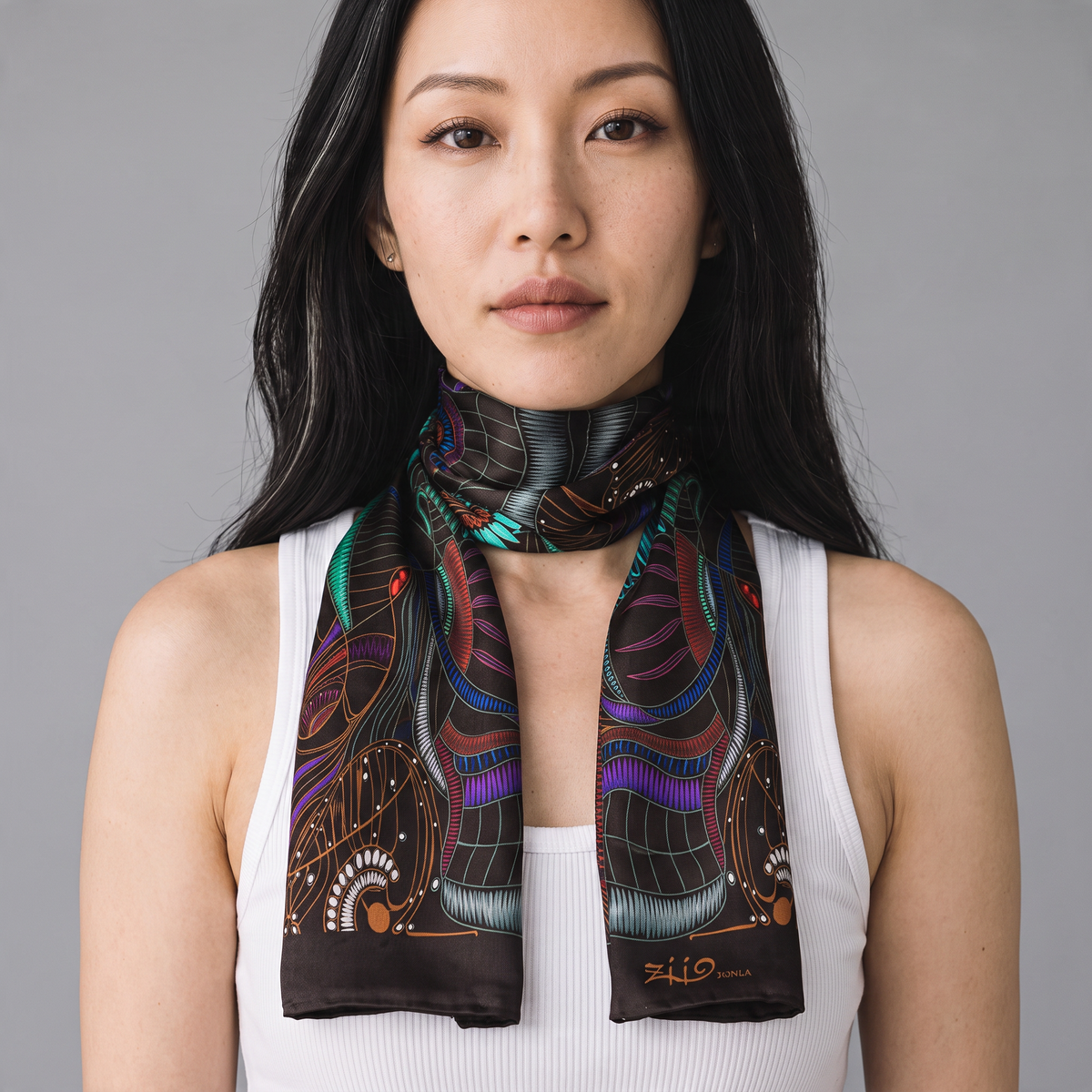 Trebor Style Ziio silk satin tube scarf with black jungle print worn by a woman against a grey background