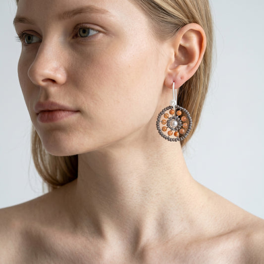 Trebor Style Ziio Soleil oval earring with tangerine carnelian, grey Murano glass beads, and a central white pearl.