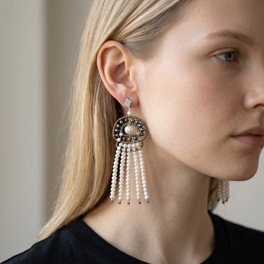 Trebor Style Ziio chandelier earrings featuring white freshwater pearl tassels, baroque pearls, and pyrite accents.